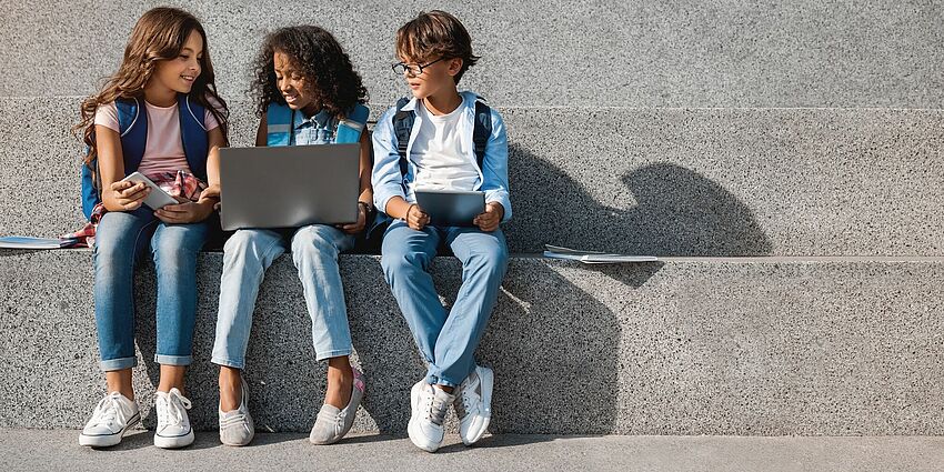 Photo of kids with digital devices