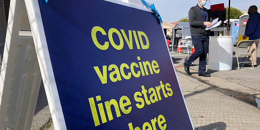 sign showing COVID19 vaccine line