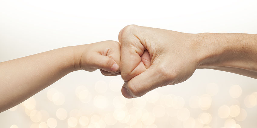 child giving an adult a fistbump