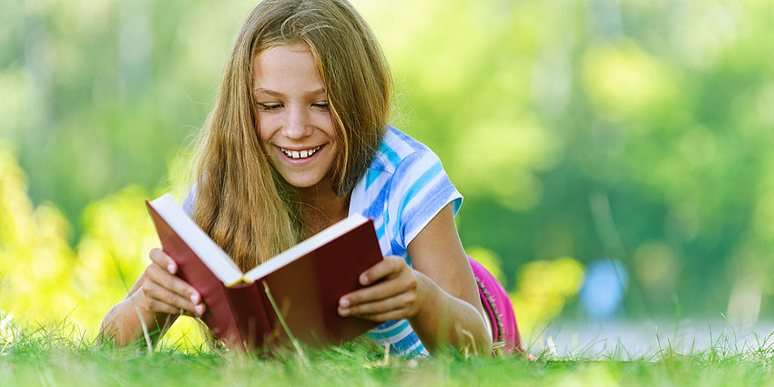 girl reading in park