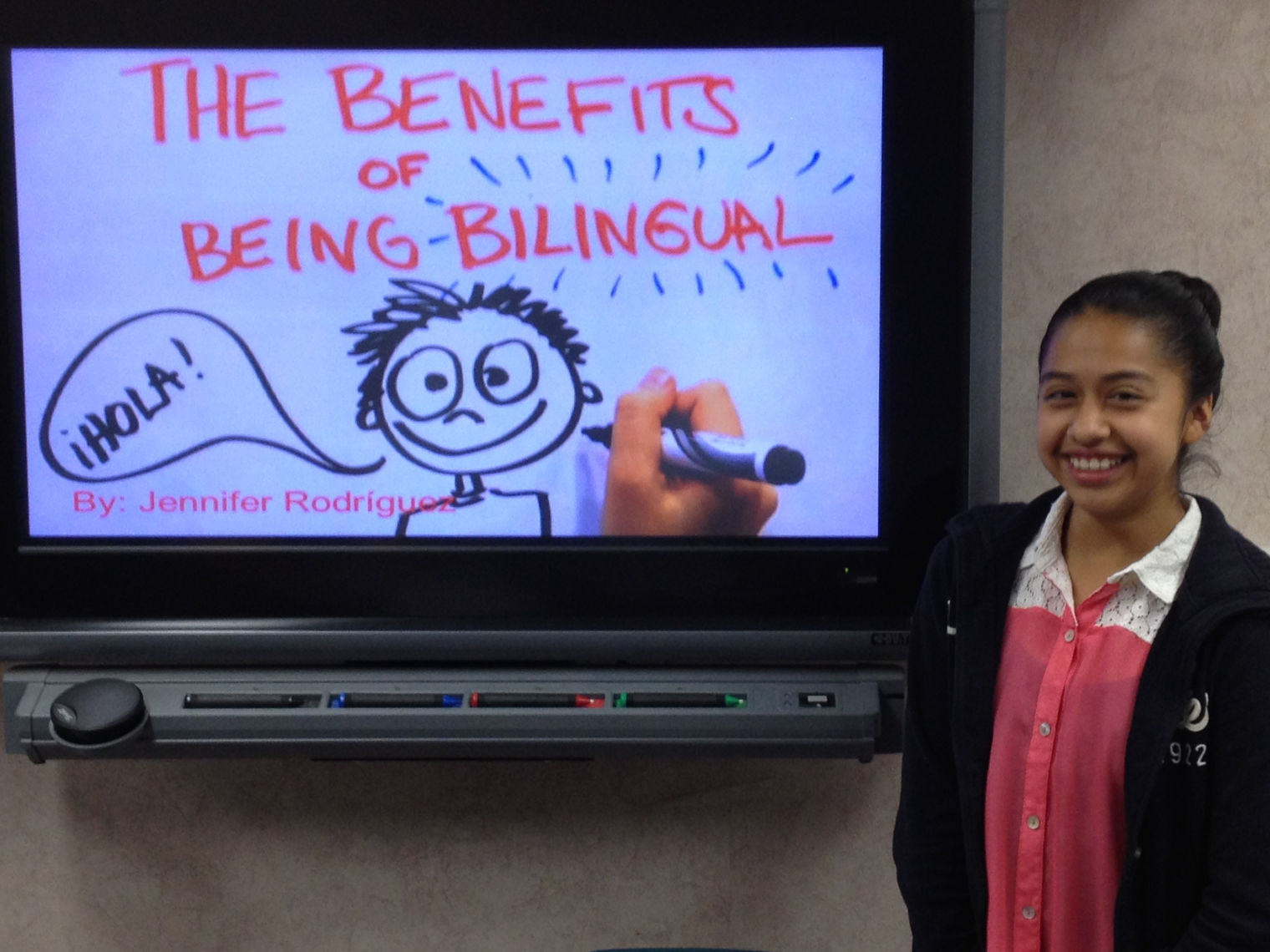 girl in front of biliteracy sign