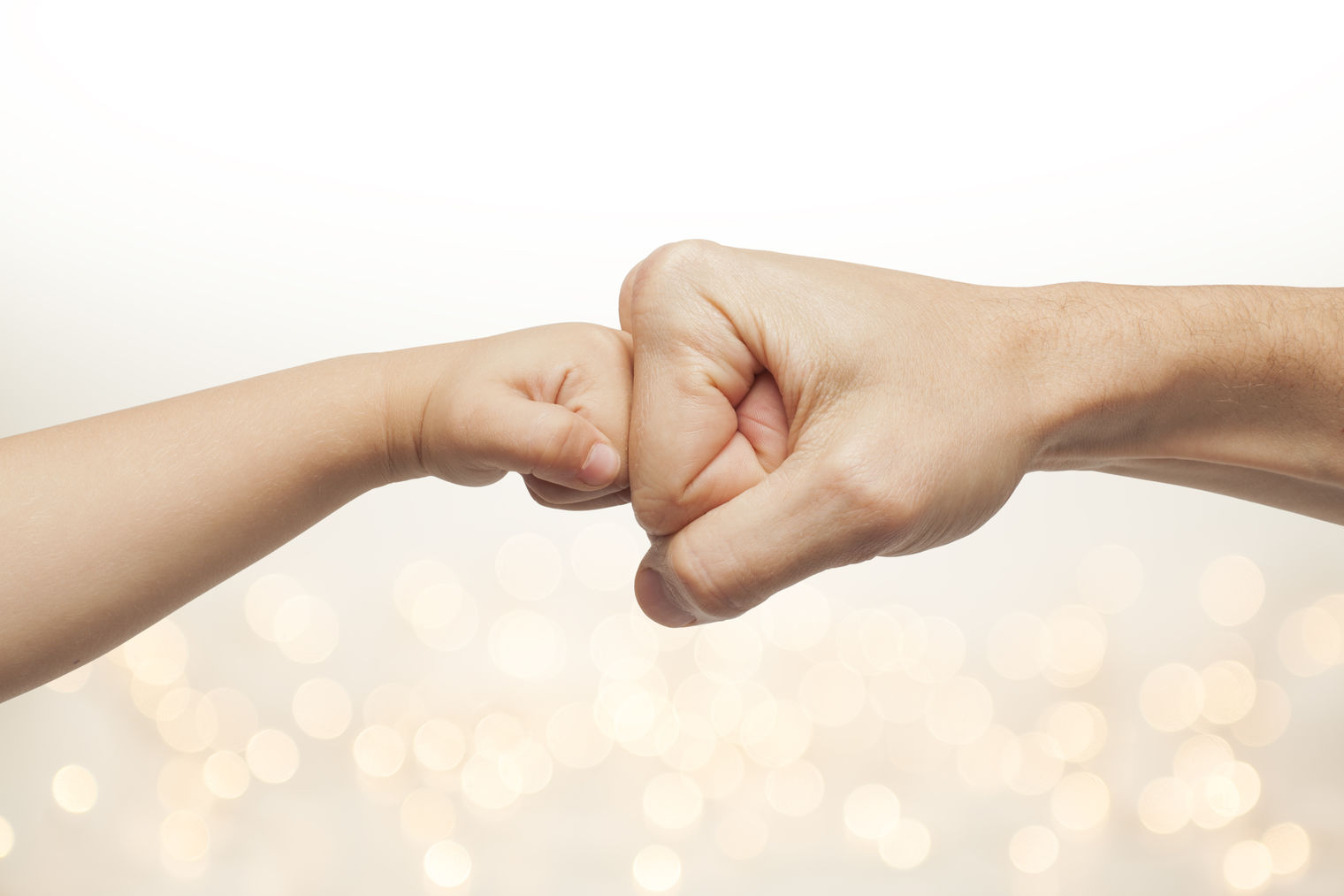 child giving an adult a fistbump