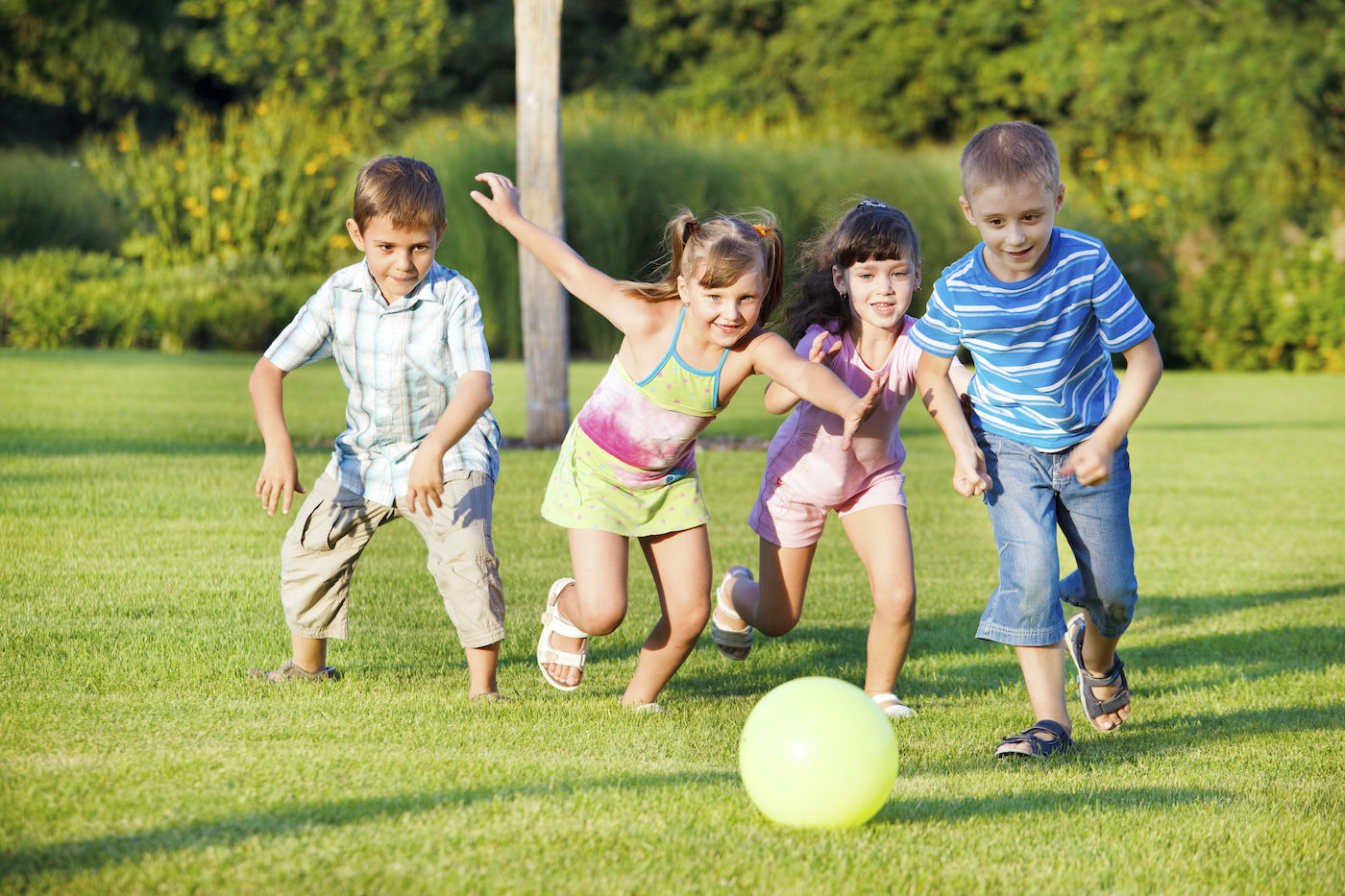 4 children chasing a ball